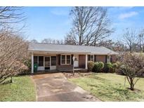 Charming single-story brick home with a covered front porch and well-maintained lawn at 1523 Delia Dr, Decatur, GA 30033