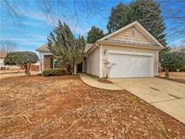 Charming one-story home featuring a two-car garage and well-maintained front yard at 351 Beckenham Ln, Dacula, GA 30019