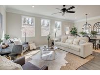 Bright living room featuring modern decor, hardwood floors, and large windows at 4537 Moray Dr, Mableton, GA 30126