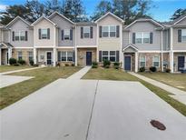 Inviting townhome exteriors with individual driveways, well-maintained lawns, and neutral color schemes at 6077 Oakley Rd, Union City, GA 30291