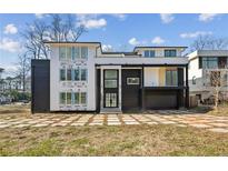 Modern home with black and white exterior and large windows showcasing a contemporary design at 1410 Lavista Ne Rd, Atlanta, GA 30324