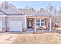 Charming townhome featuring a cozy front porch and attached one-car garage at 530 Vandenburg Dr, Villa Rica, GA 30180