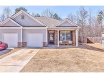 Charming townhome with a welcoming front porch and attached one-car garage at 530 Vandenburg Dr, Villa Rica, GA 30180