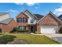 Charming two-story brick home with well-manicured lawn and attached two-car garage at 480 Glenns Farm Way, Grayson, GA 30017