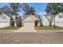 Charming new construction homes with sidewalks, manicured lawns, and inviting curb appeal on a bright, sunny day at 2208 Croghan Dr, Hampton, GA 30228