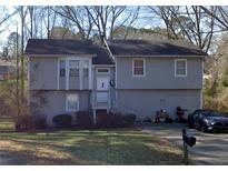 Split level home with light gray siding and a well-maintained front yard at 850 Sheppard Cv, Stone Mountain, GA 30083