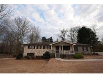 Charming single-story brick home featuring a covered porch and well-maintained front yard at 4973 Horton Pl, Douglasville, GA 30135