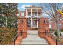 Charming brick home featuring a covered front porch and beautiful architectural details at 639 Brennan Dr, Decatur, GA 30033