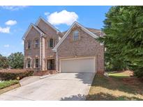 Traditional two-story brick home features an attached two-car garage and manicured landscaping at 3113 Brians Creek Se Dr, Conyers, GA 30013