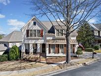 Charming two-story home with a welcoming front porch and meticulously landscaped yard at 3015 Woodvale Ct, Alpharetta, GA 30022