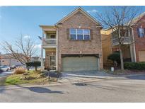 Charming two-story brick home featuring a front-entry garage and an inviting second story balcony at 1600 Yukon Ct, Atlanta, GA 30349
