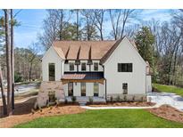Stunning two-story home with a manicured lawn, stone accents, and a welcoming facade at 1445 Ashwoody Ne Ct, Atlanta, GA 30319