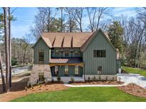 Stunning exterior view of home with green siding, stone accents, and a well-manicured lawn at 1445 Ashwoody Ne Ct, Atlanta, GA 30319
