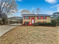 Charming two-story home with red shutters, white door, and attached carport at 6742 Green Meadows Ln, Morrow, GA 30260
