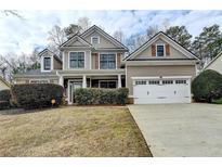 Charming two-story home featuring a well-manicured front yard and attached two-car garage at 159 Park Pointe Way, Suwanee, GA 30024