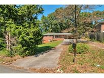 Traditional one-story home with a brick facade and a long driveway at 2837 Davidson Dr, Lithonia, GA 30058