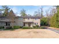 Inviting townhome with modern facade, manicured landscaping, and a well-kept lawn at 4060 Haverhill Ne Dr # F, Atlanta, GA 30342