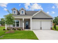 Charming one-story home with gray siding, white trim, a well-manicured lawn, and a two-car garage at 184 Vinca Nw Cir, Kennesaw, GA 30144