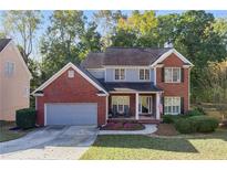 Beautiful two-story brick home featuring a well-manicured lawn and attached two-car garage at 315 Hunters Trce, Dallas, GA 30157