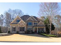 Stunning front exterior of home showcasing stone accents and a meticulously maintained front yard at 4095 Copper Leaf Ln, Cumming, GA 30040