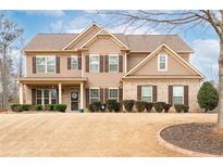 Traditional two-story home with a well-manicured lawn, complemented by shrubs along the front and an inviting entrance at 2600 Reece Farms Sw Trl, Powder Springs, GA 30127
