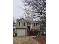 Charming two-story home with vinyl siding, a small front yard, and a one-car garage at 4233 Viewpoint Ln, Ellenwood, GA 30294