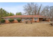 Charming single-story brick home featuring a well-maintained lawn and a convenient carport at 3948 Bright Star Rd, Douglasville, GA 30135