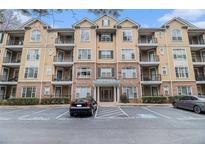A stately condo building features a meticulously maintained facade and well-manicured landscaping at 2201 Stratford Commons, Decatur, GA 30033