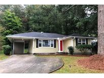 Charming ranch-style home featuring a carport and a welcoming red front door at 5901 Club Se Dr, Mableton, GA 30126