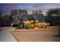 Beautiful two-story home featuring a stone facade, manicured lawn, and welcoming curb appeal at 149 Avalon Way, Sharpsburg, GA 30277