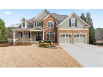 Charming two-story home with a stone and siding exterior, two-car garage, and well-manicured lawn at 3130 Kates Nw Way, Kennesaw, GA 30152