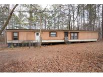 Single-story home featuring a traditional facade, multiple entry points and yard at 559 Quail Trail Rd, Auburn, GA 30011