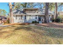 Charming two-story home featuring a landscaped front yard and second story balcony at 3225 Redona Dr, Atlanta, GA 30349