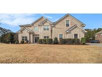 Beautiful two-story brick home with manicured landscaping and a well-maintained lawn at 15 Sugarmaple Ct, Oxford, GA 30054