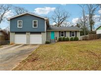 Charming home with a teal door, two-car garage and blue and grey accents at 2235 Emerald Springs Dr, Decatur, GA 30035