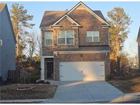Charming two-story home with a brick and stone facade and an attached two-car garage at 623 Wayland Ct, Fairburn, GA 30213