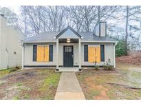 Charming home featuring a gray exterior, black shutters and a well-maintained lawn at 2370 Wingfoot Pl, Decatur, GA 30035