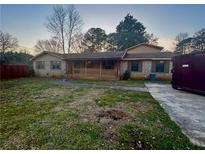 Charming brick home featuring a cozy front porch and ample yard space at 74 Cooper Dr, Dallas, GA 30157