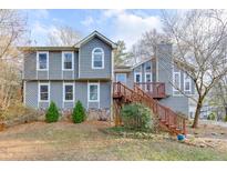 Charming two-story home featuring a stone foundation and inviting wooden staircase at 3852 Old Bridge Way, Duluth, GA 30096