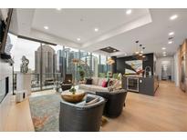 Bright, open living area with floor-to-ceiling windows and hardwood floors overlooks the cityscape at 40 12Th Ne St # 1503, Atlanta, GA 30309