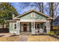 Charming green craftsman-style home with inviting front porch and brick pathway at 902 E Ponce De Leon Ave, Decatur, GA 30030