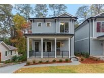 Charming two-story home featuring a welcoming front porch and craftsman details in a landscaped front yard at 660 Timm Valley Ne Rd, Atlanta, GA 30305