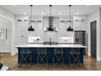 Bright kitchen features stainless steel appliances, a large island with seating, and pendant lighting at 660 Timm Valley Ne Rd, Atlanta, GA 30305