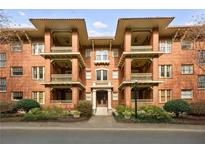 Classic brick building with elegant balconies, featuring a landscaped entrance at 266 11Th St # 103, Atlanta, GA 30309