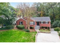 Charming brick home with a well-maintained lawn and mature trees at 2612 Arlene Ne Way, Atlanta, GA 30305