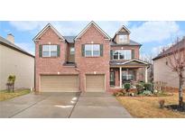 Two-story brick home featuring an attached two-car garage and well-manicured landscaping at 2656 Muskeg Sw Ct, Atlanta, GA 30331