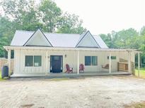 Charming home with a covered porch and metal roof at 4267 Klondike Rd, Lithonia, GA 30038
