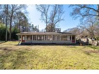 Spacious backyard featuring a charming one-story home with large windows at 382 Golfview Nw Rd, Atlanta, GA 30309