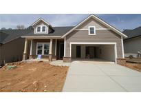 New construction home featuring a covered porch with brick accents and an attached two-car garage at 2017 Ripple Park Bnd, Canton, GA 30114