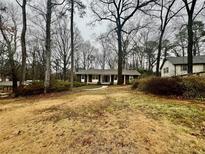 Charming ranch-style home with a well-manicured lawn and mature trees at 2480 Glenbonnie Dr, Dunwoody, GA 30360